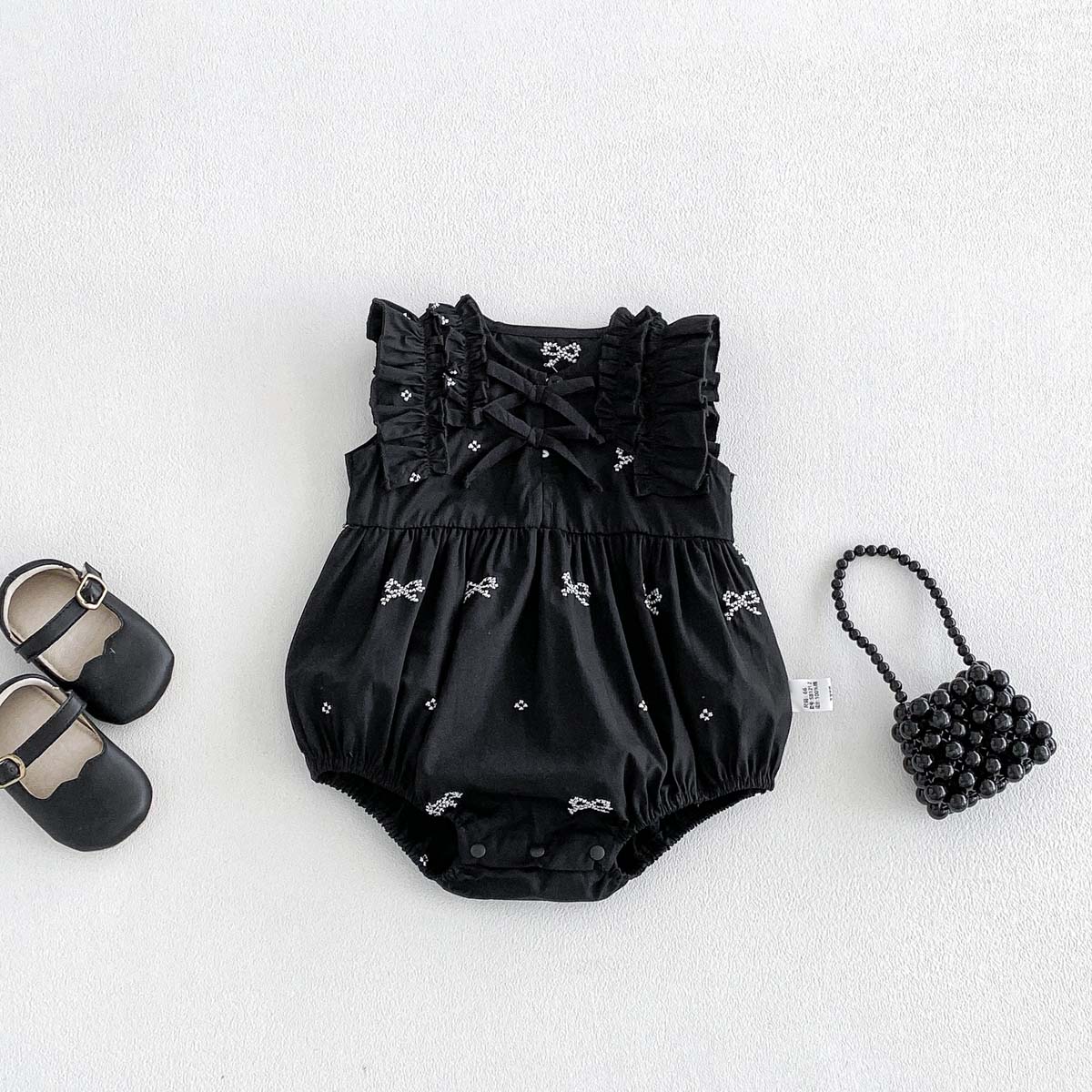 女の赤ちゃんブラックボウプリントロンパースノースリーブフリル - Baby Clothing Online のレビューと価格